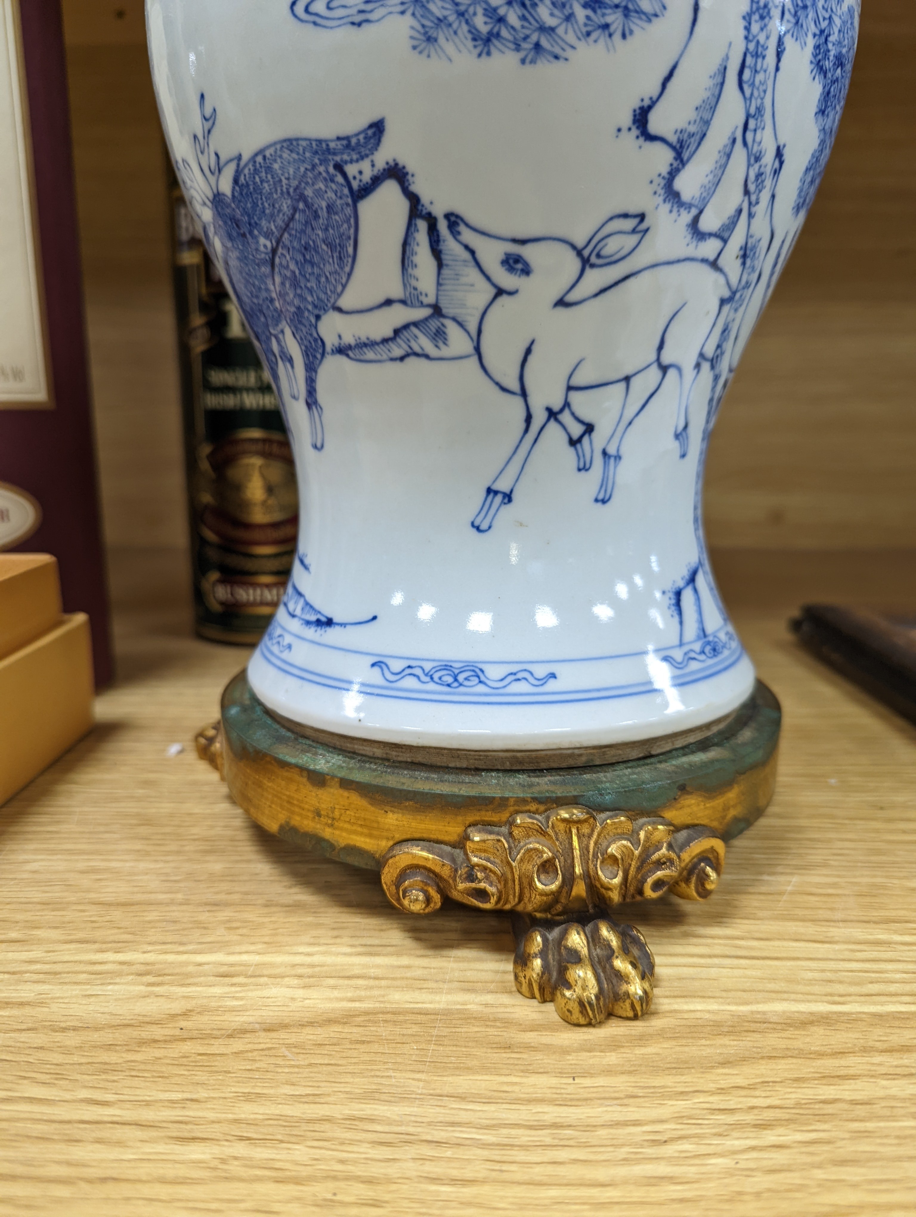 A Chinese blue and white baluster vase, brass mounted 29cm